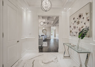 All white hallway with marble floor staged with silver decor by StyleBite condo and home staging services in Toronto