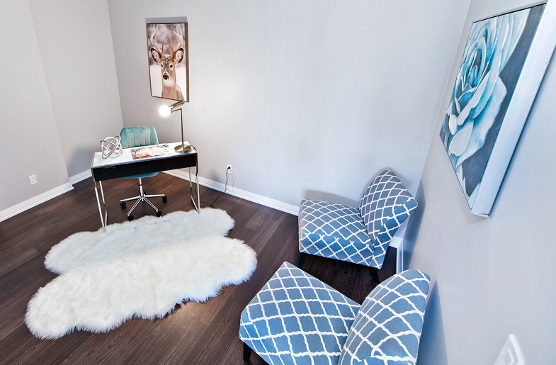 Office room staged with blue chairs and white desk by StyleBite condo and home staging services in Toronto