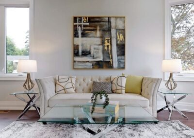 Sitting area staged with white couch and gold decor by StyleBite home staging services in Toronto.