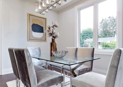 Small dining area staged with crystal table and grey chairs by StyleBite home staging services in Toronto