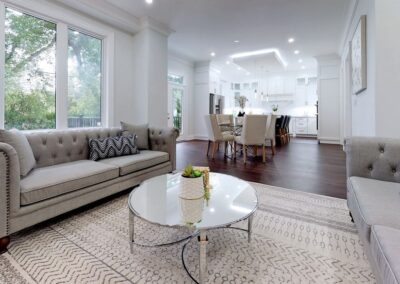 Open floor plan living room staged with beige and white furnitures by StyleBite home staging services in Toronto.