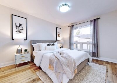 Bedroom staged with white furnitures and grey decor by StyleBite home staging services in Toronto.