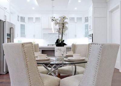 Kitchen staged with silver and white furnitures and round crystal table by StyleBite home staging services in Toronto.