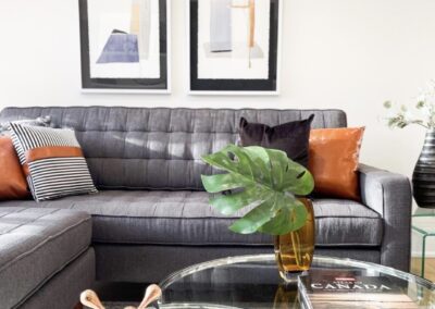 Client's black couch staged with colorful pillows by StyleBite home staging services in Toronto.