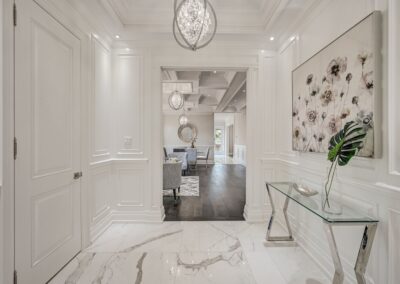 All-White hallway staged with crystal table and silver decor by StyleBite home staging services in Toronto.