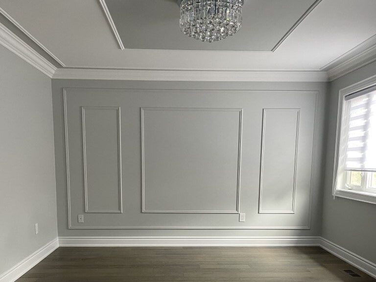 Empty grey bedroom with crystal chandelier and window before staging by StyleBite home staging services in Toronto.