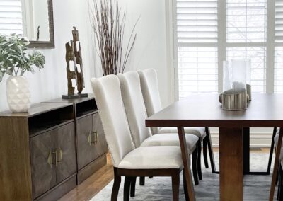 Dining room staged with white chairs and wood furniture by StyleBite condo and home staging services in Toronto