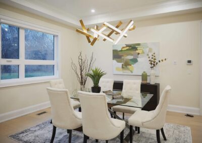 Dining room staged with white chairs and gold decor by StyleBite condo and home staging services in Toronto