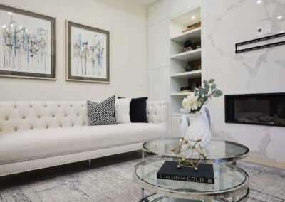 Marble wall staged with white furniture and painting for decor by StyleBite condo and home staging services in Toronto