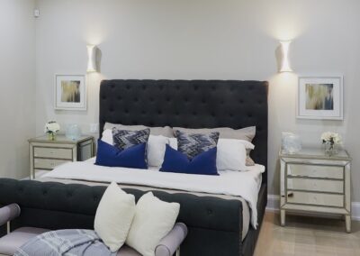 Bedroom staged with black headboard and gold furniture by StyleBite home staging services in Toronto.