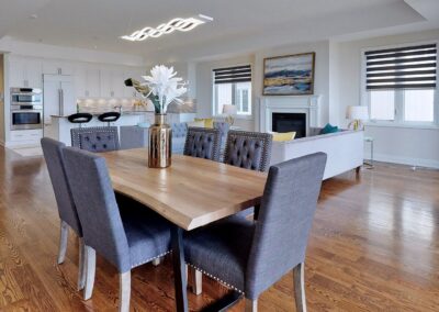 Living and dining room staged with grey chairs and wood table by StyleBite condo and home staging services in Toronto