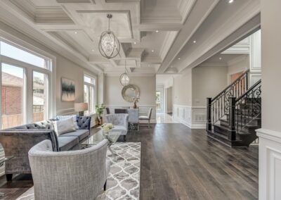 Open floor plan living room staged with grey furnitures by StyleBite home staging services in Toronto.