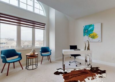 Office area staged with turquoise chairs next to big window view by StyleBite condo and home staging services in Toronto