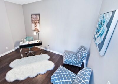 Office room staged with blue and turquoise chairs with white rug by StyleBite home staging services in Toronto.