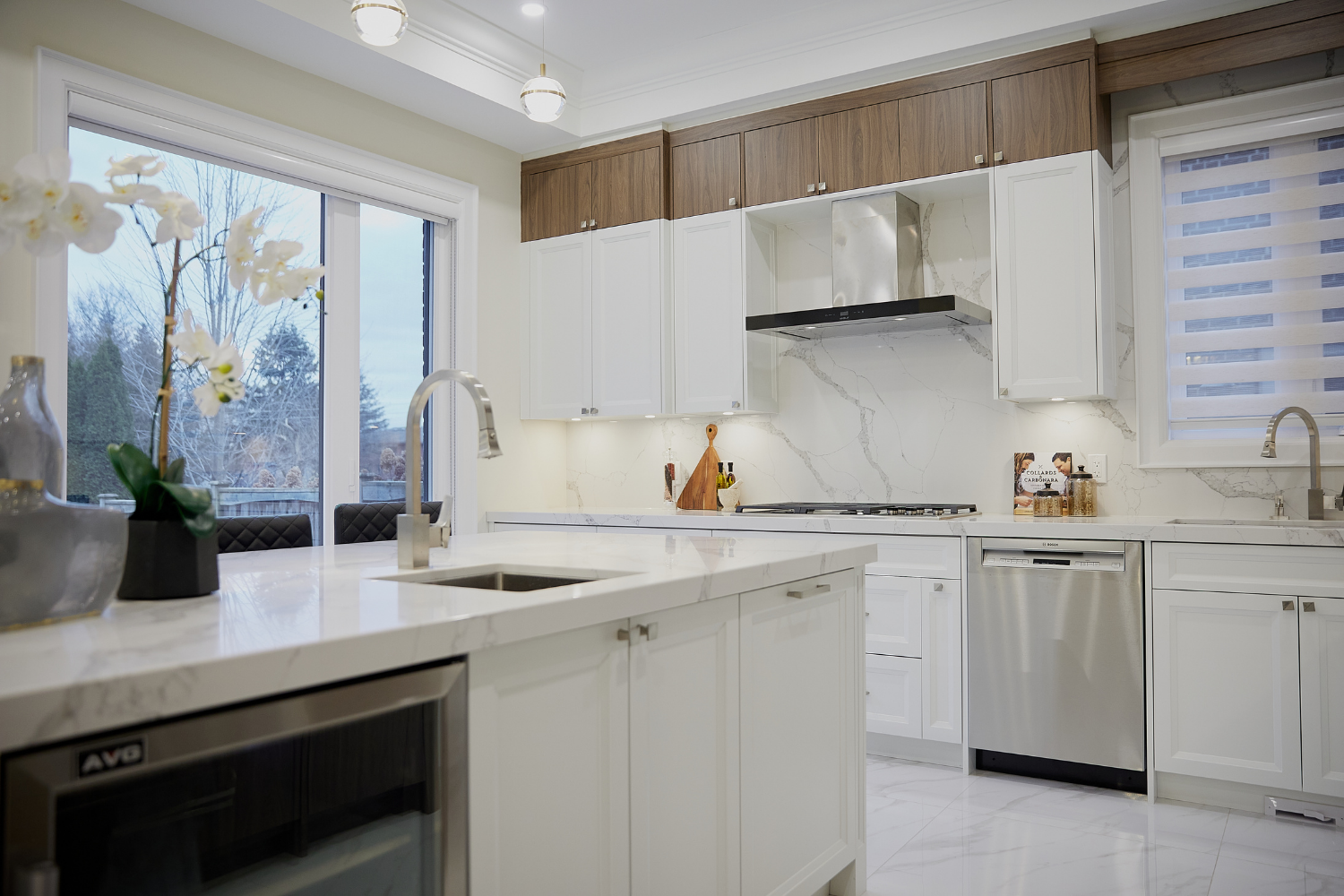 Kitchen beautifully staged by StyleBite with utensils, white flowers and bright lightning.