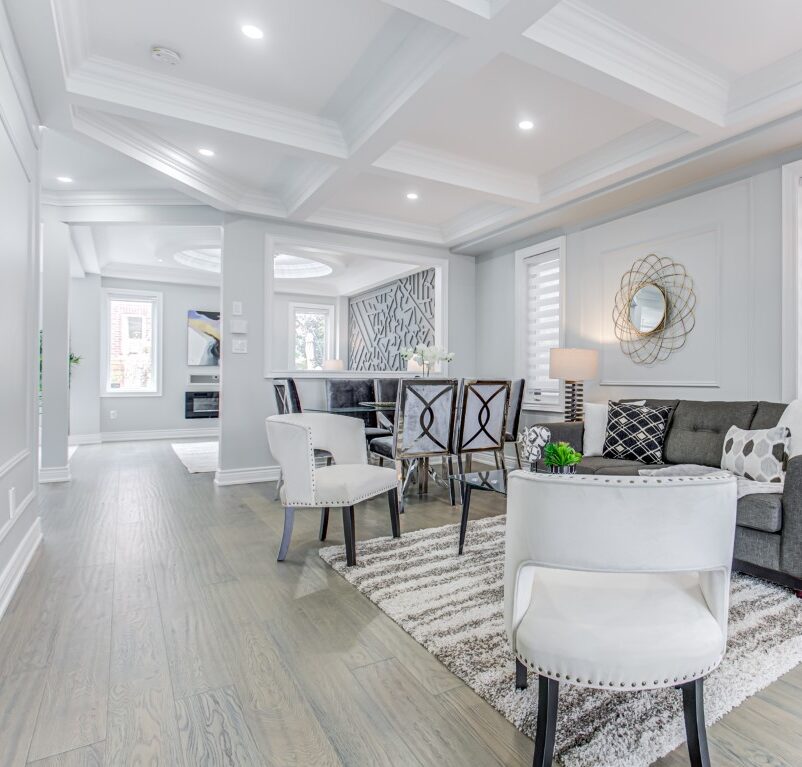 Living and dining area staged with white and grey furnitures by StyleBite home staging services in Toronto.