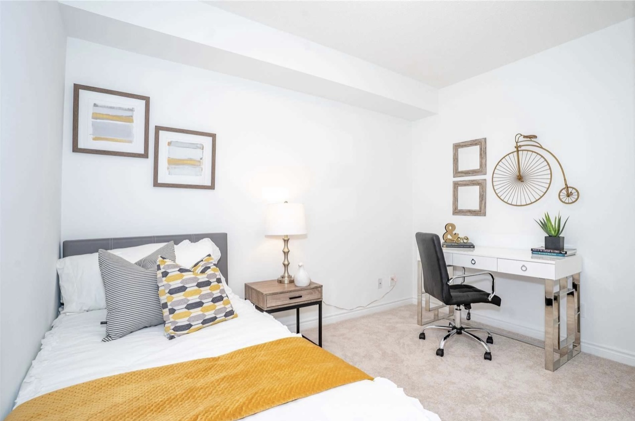 All white bedroom condo for sale staged with grey and yellow decor by StyleBite Staging services in Toronto.