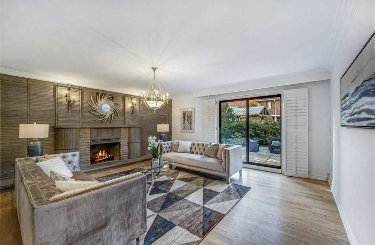 Wood wall living room with access door to terrace condo for sale staged by StyleBite Staging services in Toronto. 