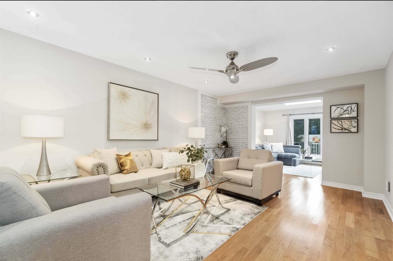 Staged condo for sale after decluttering with all beige decor and crystal tables by StyleBite Staging in Toronto.