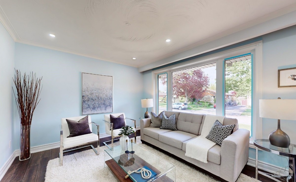 A professionally staged living room by StyleBite Staging in Toronto, featuring warm neutral tones, cohesive furniture arrangement, and tasteful décor designed to appeal to buyers.