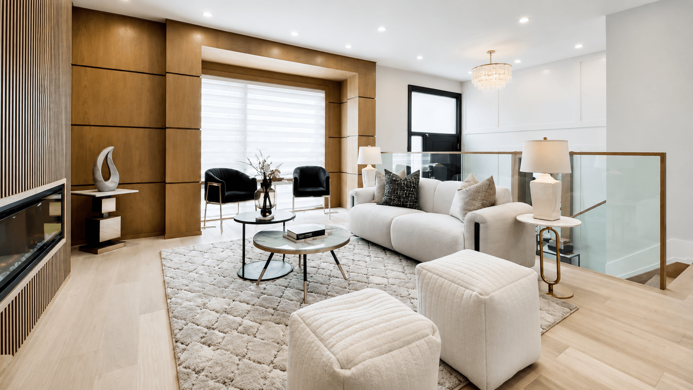 modern-living-room-interior-2400×1350 Bright contemporary living room with warm wood accents, neutral furnishings, glass railings, modern lighting, and an elegant open-plan design.